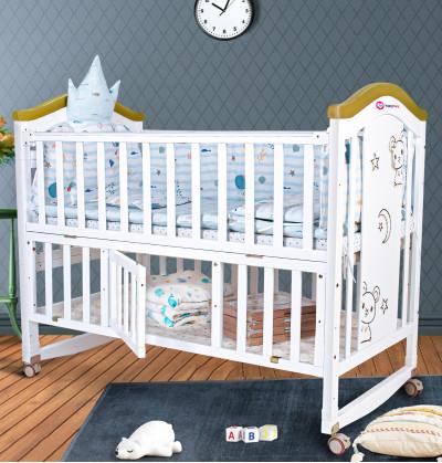 wooden cradle price with beautiful storage beneath the cot for keeping baby essentials handy.